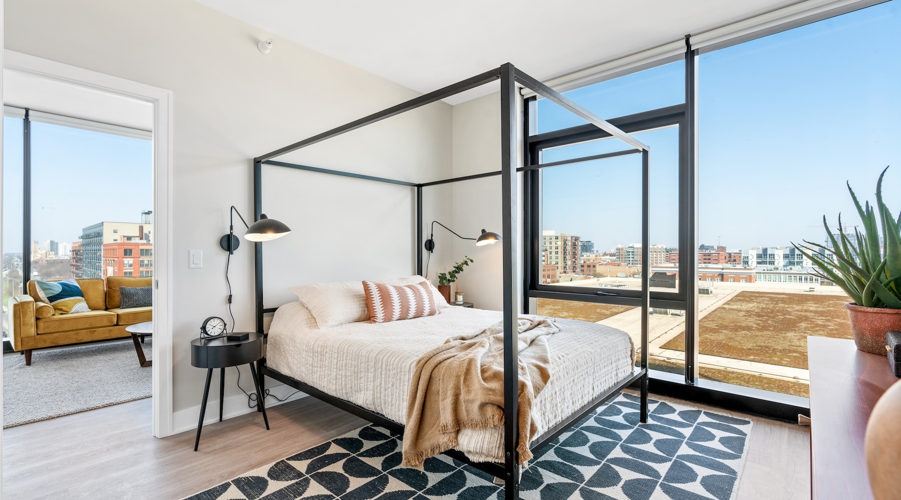 a bedroom with a bed and a large window